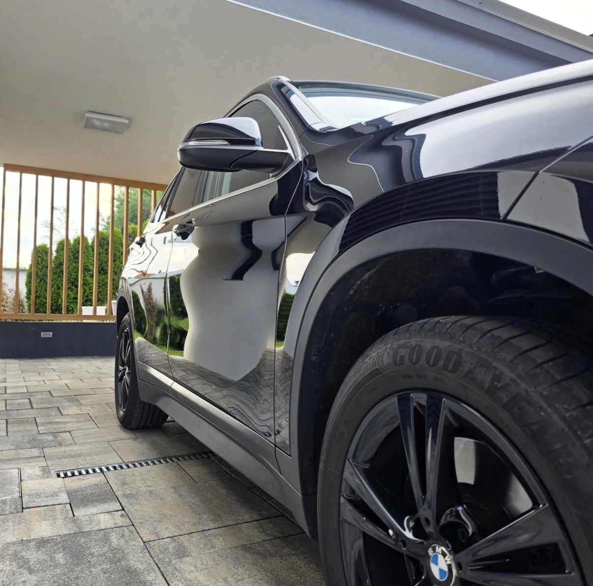 Črni BMW — odsevi na laku